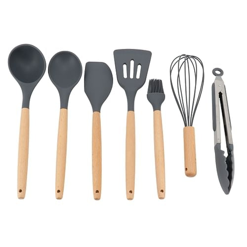 A set of seven kitchen tools with beech wood handles, including a whisk, basting brush, solid spoon, spatula, slotted turner, ladle, and tongs.