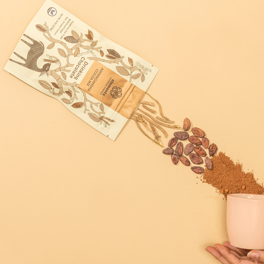 Cacao powder being poured from a small container onto a beige surface with a cacao bean packaging.