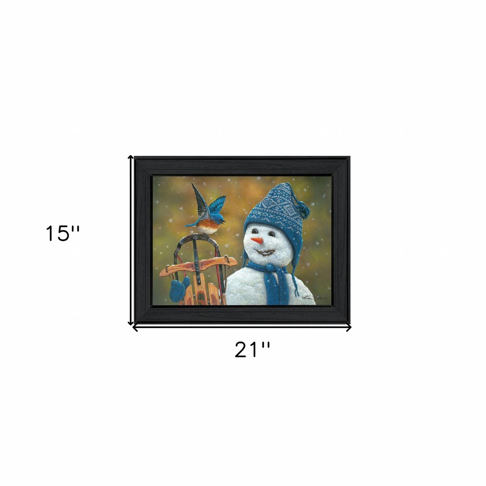 Framed artwork of a snowman with a blue hat and scarf, sitting on a bench with a bird, against a snowy background.