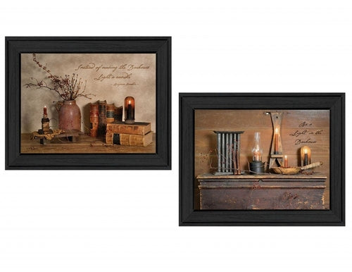 Two framed rustic wall art pieces with candles and books on a white background