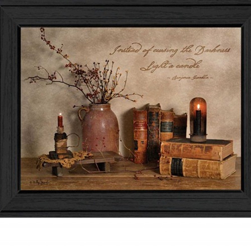 Still life arrangement with books, a vase, and candles on a textured surface with a quote.