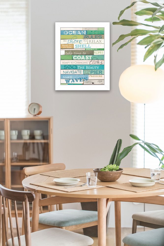 Dining room with a framed wall art piece featuring coastal-themed text.