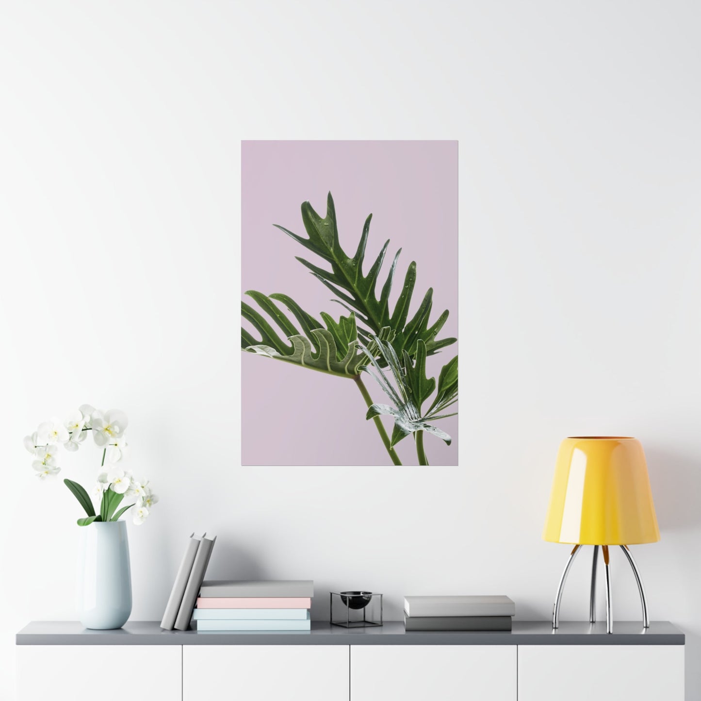 Framed plant print on a wall above a shelf with decor items.