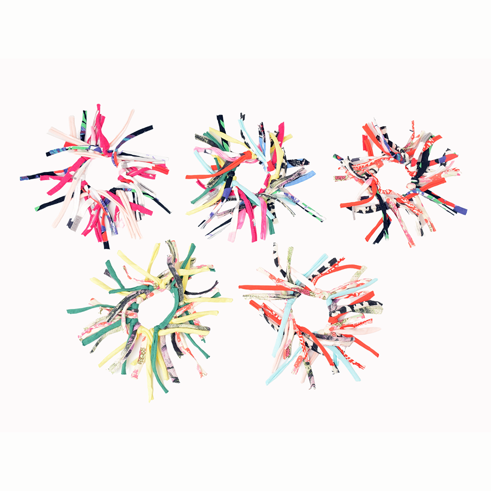 Colorful hair ties arranged in a circular pattern on a white background.