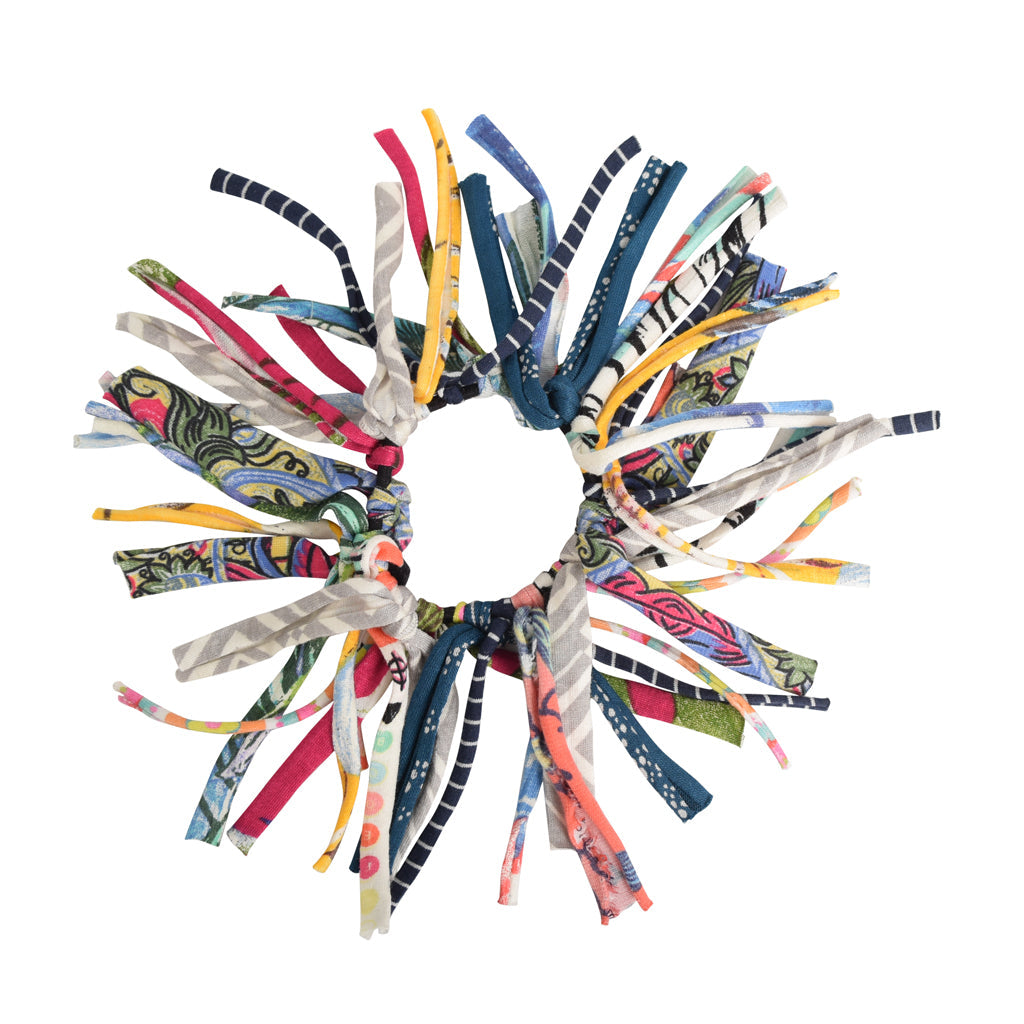 Colorful scrunchie with patterned ribbons on a white background