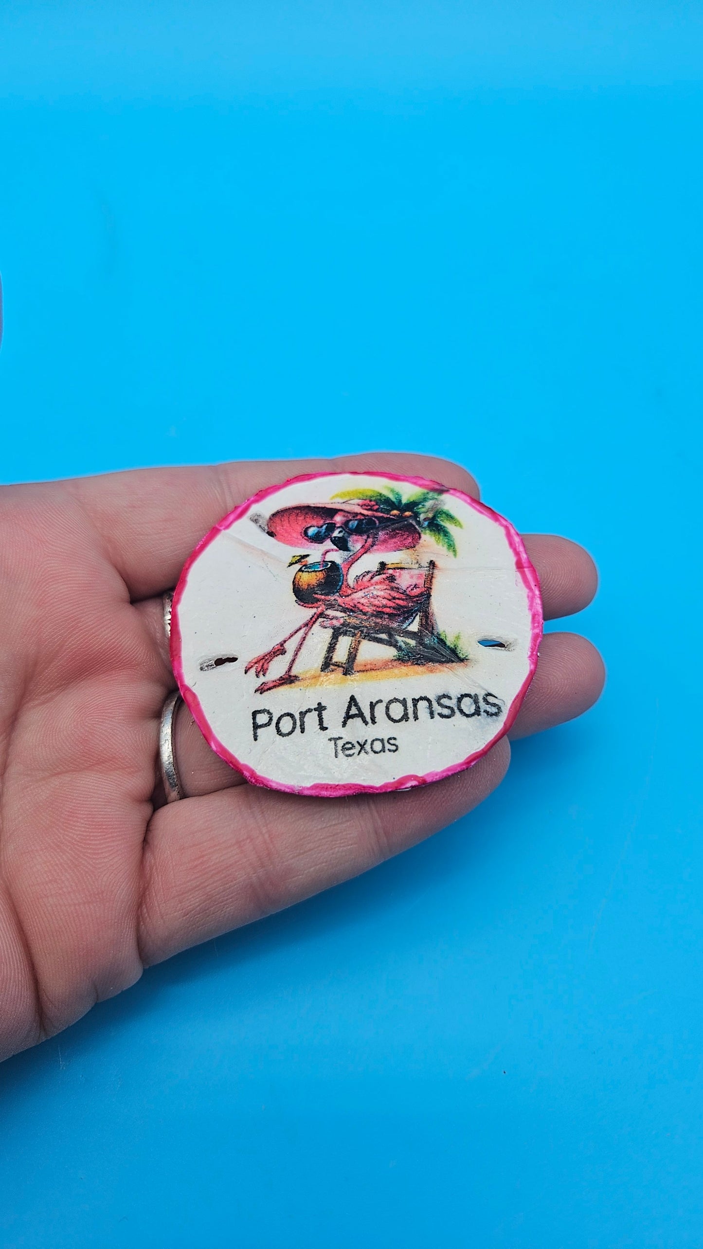 Handmade Port Aransas sand dollar magnet with flamingo design