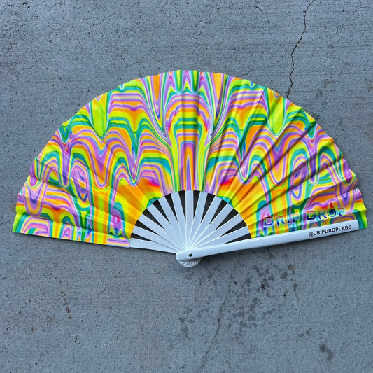 Colorful hand fan with a pattern on a gray surface