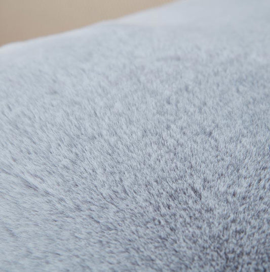 Close-up of a textured light blue fabric surface
