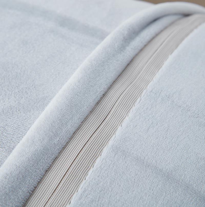 Close-up of light gray fabric with a ribbed texture