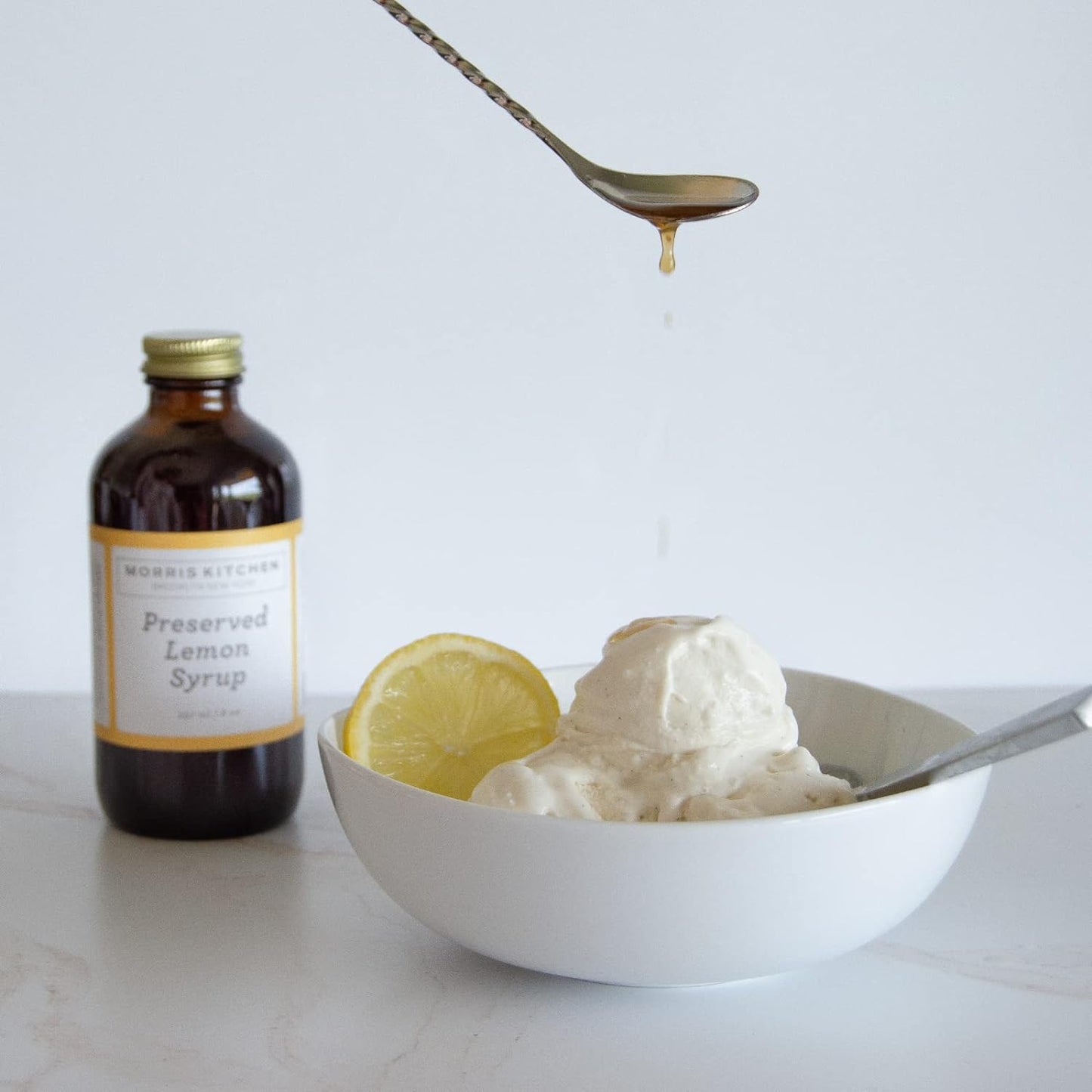 limon syrup and ice cream using a spoon