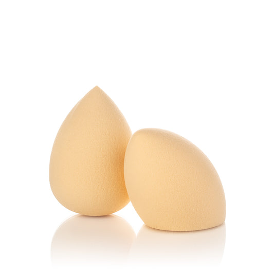Two beige makeup sponges on a white background