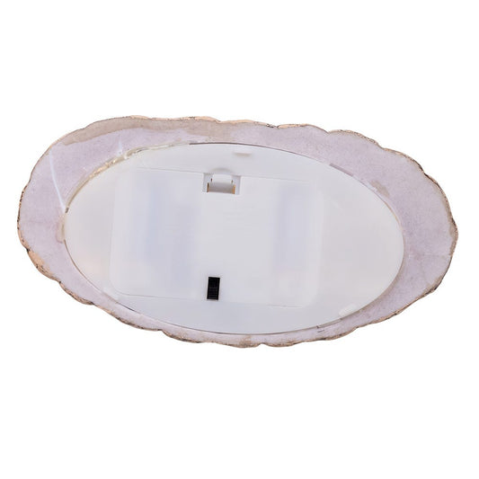 Round white light fixture with scalloped edge on a white background