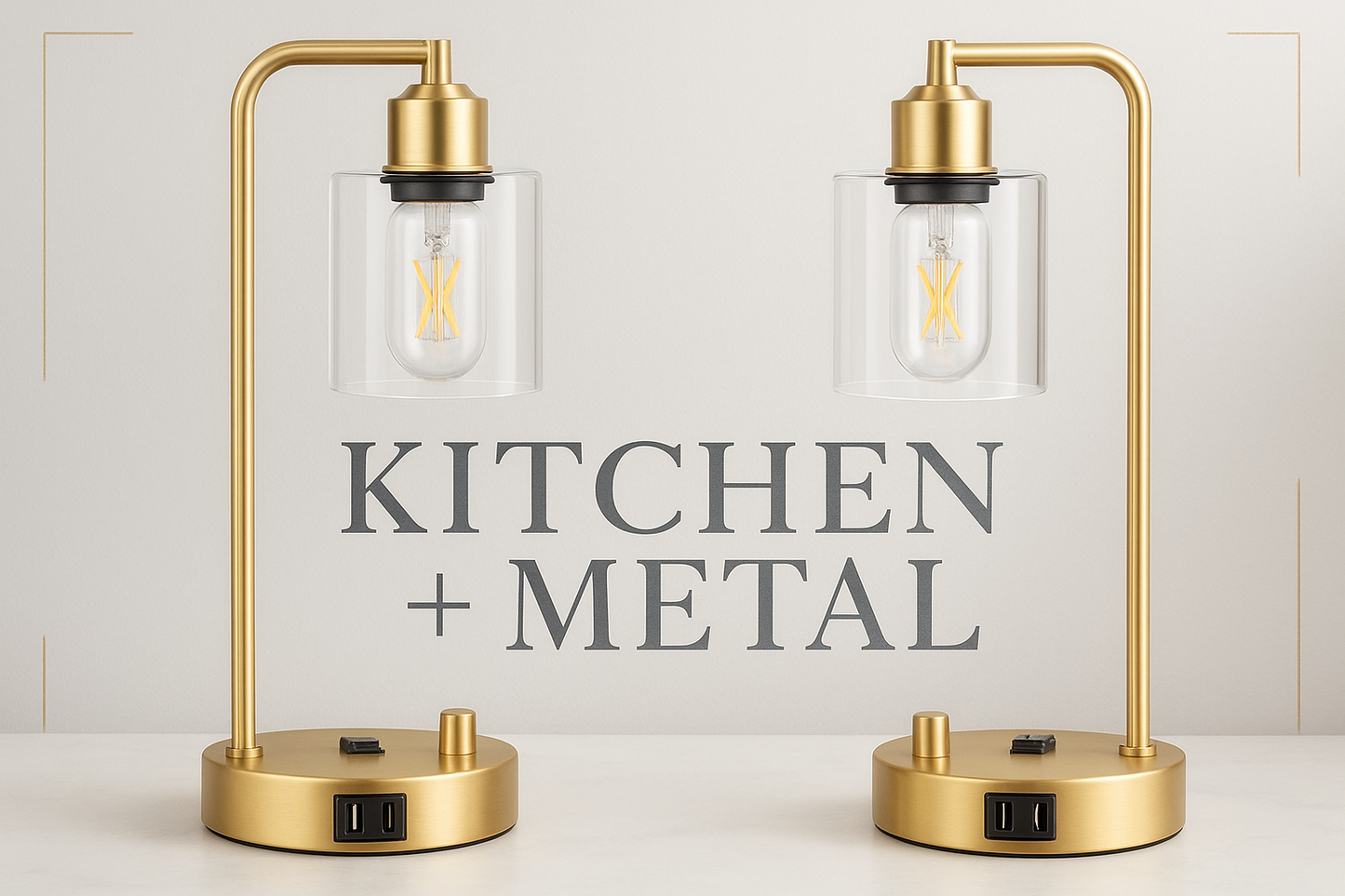 Elegant gold desk lamps with clear glass shades displayed against a sophisticated background featuring the Kitchen + Metal logo in a modern font with subtle metallic texture