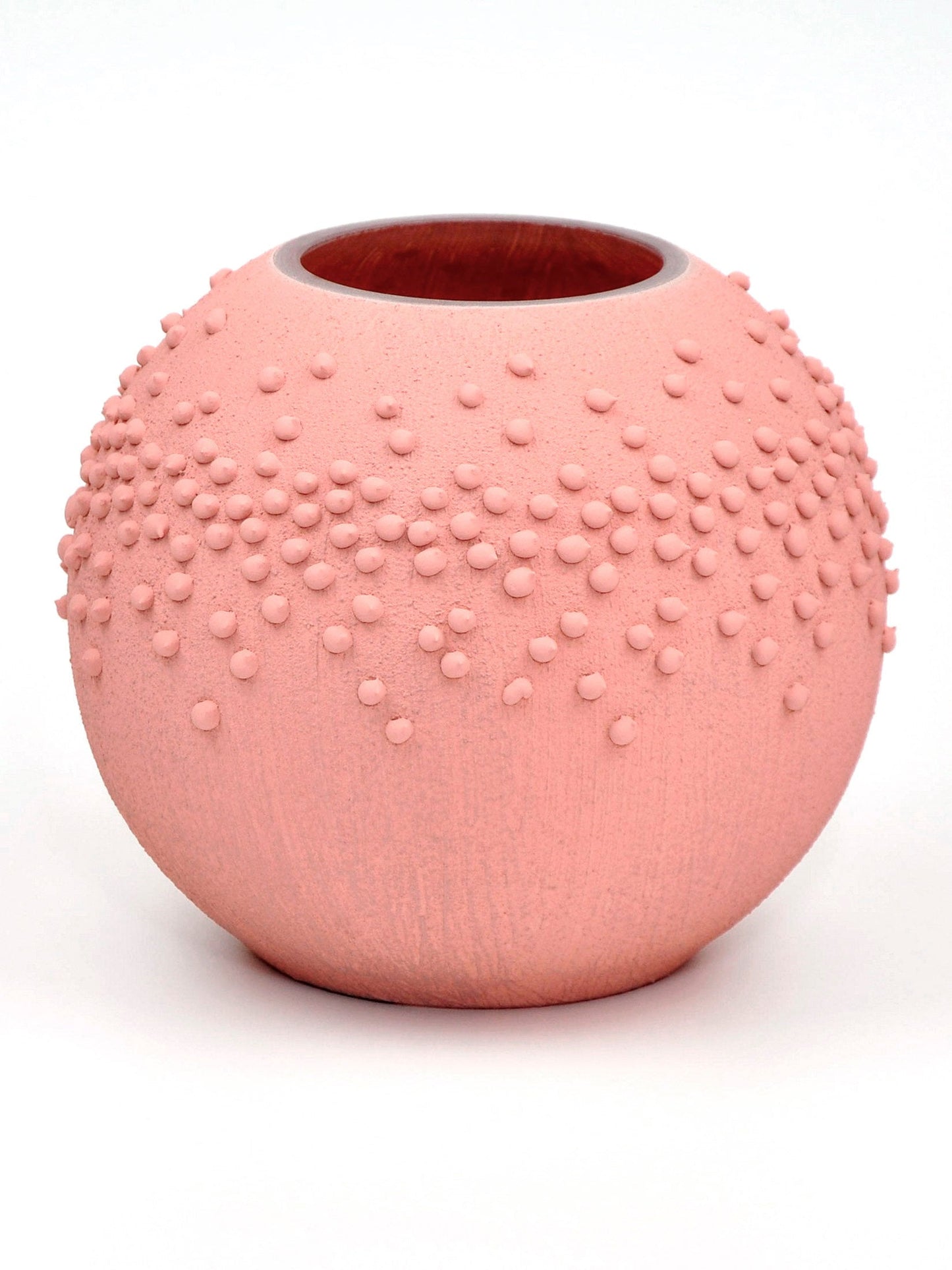 Pink textured vase on a white background