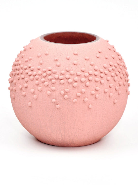 Pink textured vase on a white background