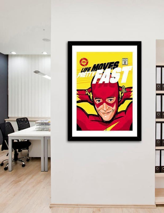 Framed superhero poster with 'Life Moves Fast' text in an office setting