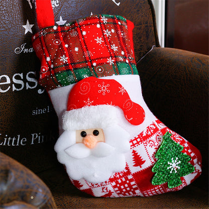 Christmas stocking with Santa face design hanging on a chair.