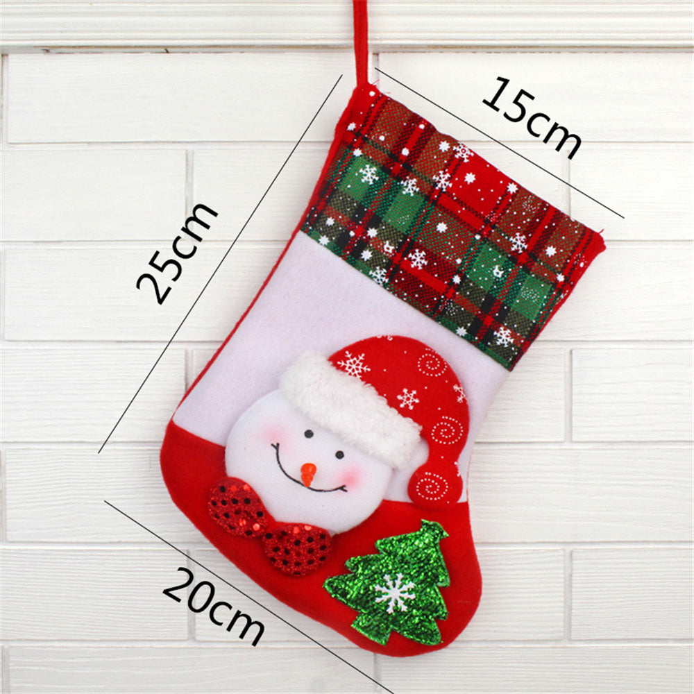 Red Christmas stocking with Santa face and tree on white brick wall with measurements.