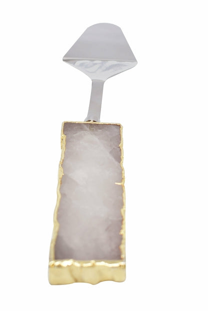 A set of three cake servers with gold trim handles and gemstone accents in amethyst, black quartz, and clear quartz.