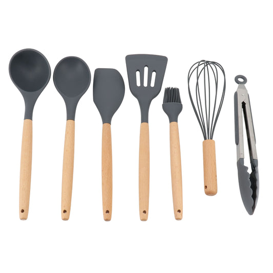 A set of seven kitchen tools with beech wood handles, including a whisk, basting brush, solid spoon, spatula, slotted turner, ladle, and tongs.