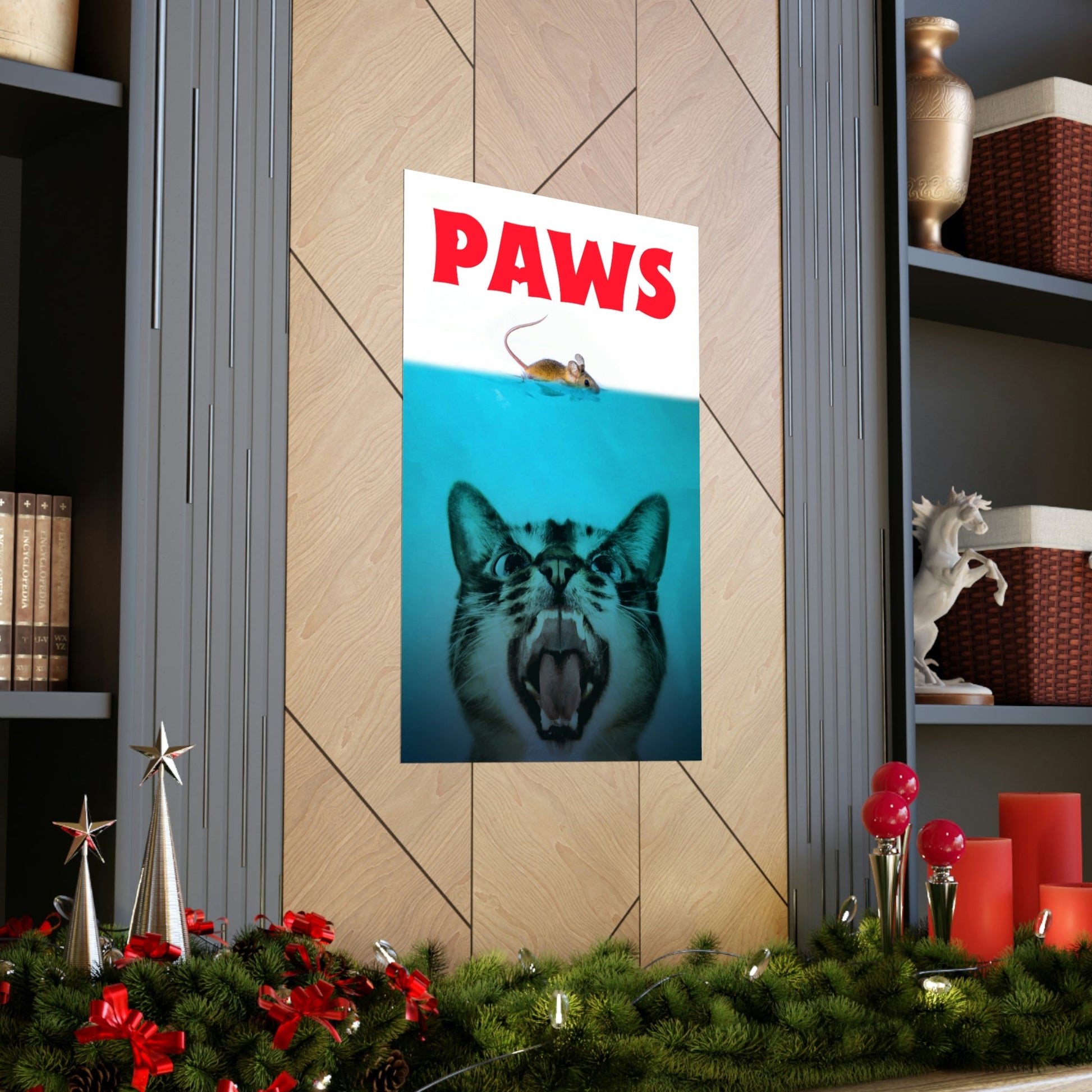 Poster with a cat and mouse design on a wall above a Christmas tree.