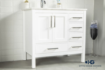 White bathroom vanity with sink and drawers in a bathroom setting.