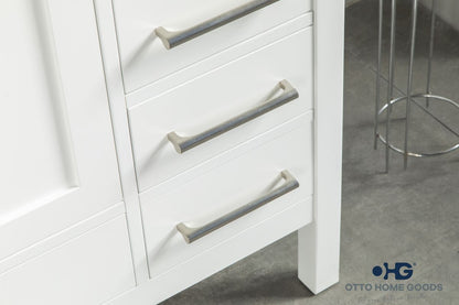 White bathroom vanity with silver handles on a gray floor.