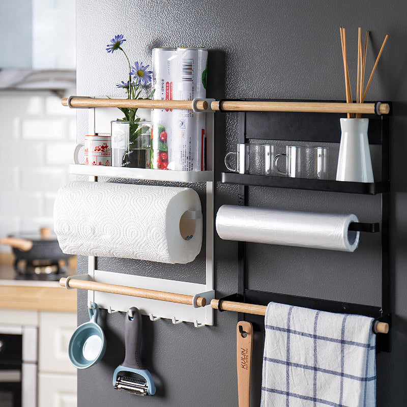 Kitchen wall-mounted organizer with paper towels, towels, and utensils on a gray wall.