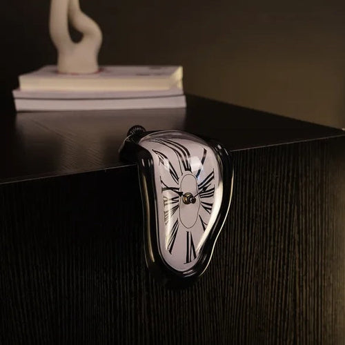 Heart-shaped clock on a dark surface with a blurred background