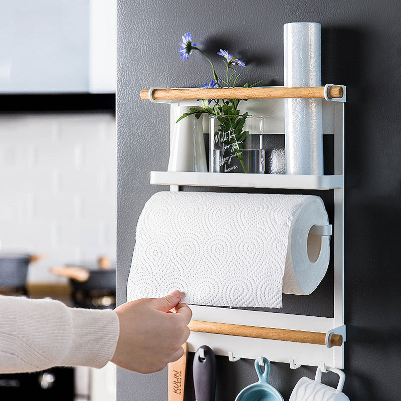 Wall-mounted kitchen organizer with paper towels, cups, and a plant.