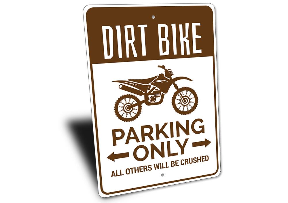 Sign with dirt bike graphic and text on a white background