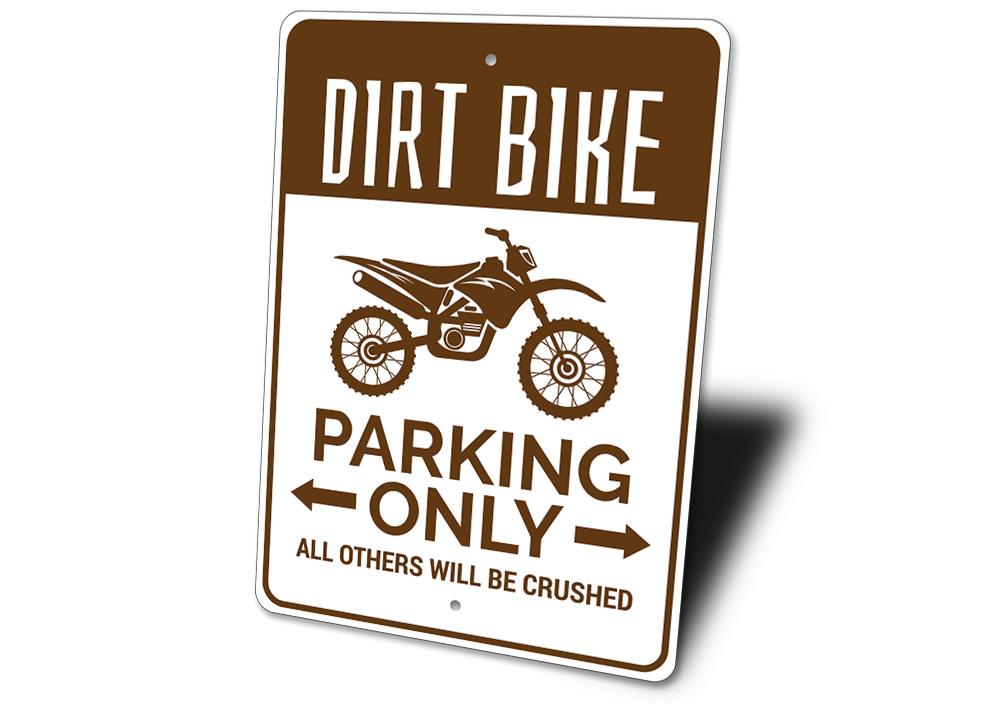 Sign with dirt bike graphic and text on a white background