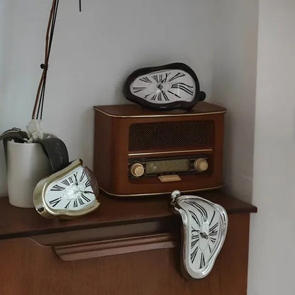 Vintage-style radio with three unique clock designs on a wooden surface.