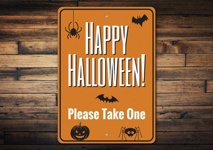 Halloween sign with text 'Happy Halloween! Please Take One' on an orange background with black text and icons.