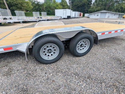 Metal trailer with wooden deck on a gravel surface