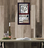 Decorative wall art with rooster design on a wooden wall above a table.