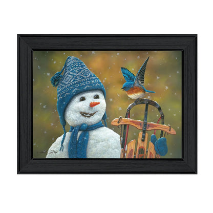 Framed artwork of a snowman with a blue knit hat and scarf, sitting on a sled with a bird perched on it, against a snowy background.