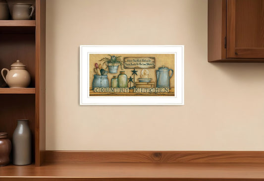 Framed artwork titled 'Country Kitchen' on a wall above a wooden shelf.