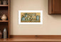 Framed artwork titled 'Country Kitchen' on a wall above a wooden shelf.
