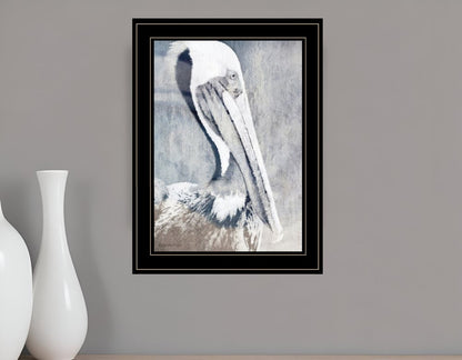 Framed artwork of a pelican on a gray wall with white vases.