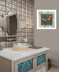 Bathroom vanity with decorative mirror and wall art featuring butterflies.