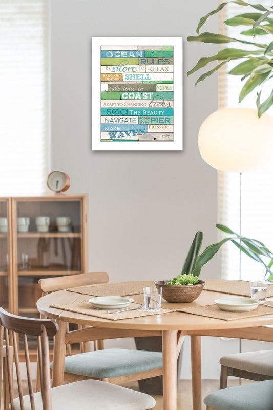 Dining room with a framed wall art piece featuring coastal-themed text.
