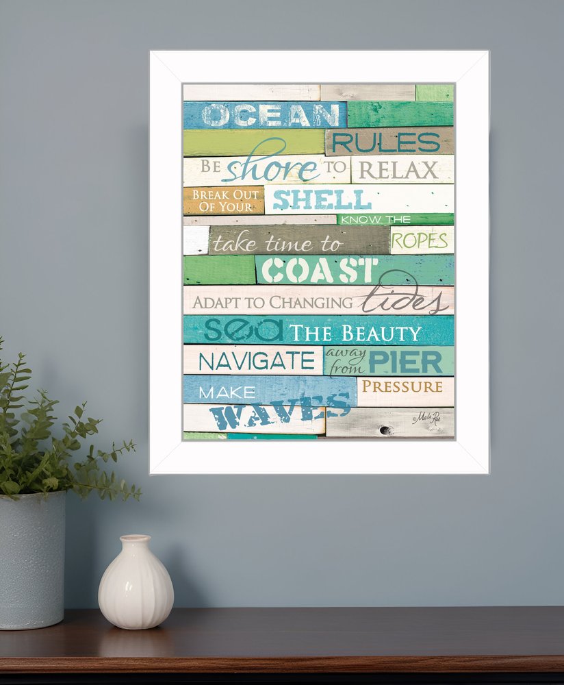 Colorful wall art with motivational phrases on a gray wall above a wooden shelf.