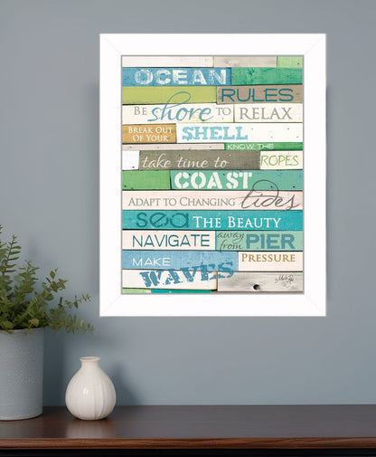 Colorful wall art with motivational phrases on a gray wall above a wooden shelf.