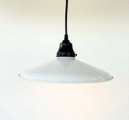 White pendant light with black fixture on a white background