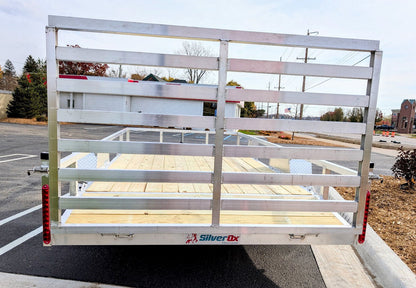 Silver Ox utility trailer on a street with a clear sky background