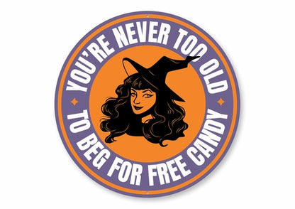 Circular sticker with a witch design and text 'You're never too old to beg for free candy' on an orange and purple background.