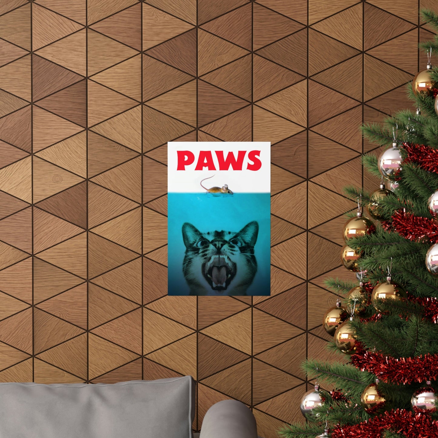 Poster with 'PAWS' and a cat's face on a geometric-patterned wall next to a decorated Christmas tree.