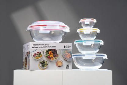 Set of glass food storage containers with lids on a gray background