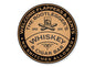 Round sign for 'The Bootlegger's Whiskey & Cigar Bar' with text and a glass of whiskey illustration.